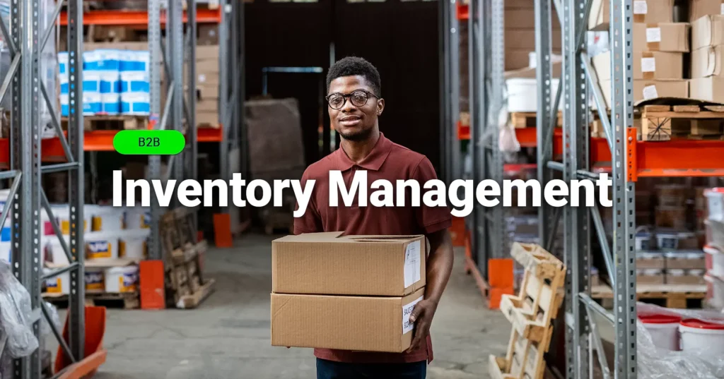 Warehouse worker carrying boxes in a B2B inventory management storage facility.