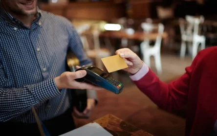 Customer making a payment using a contactless card at a POS terminal.
